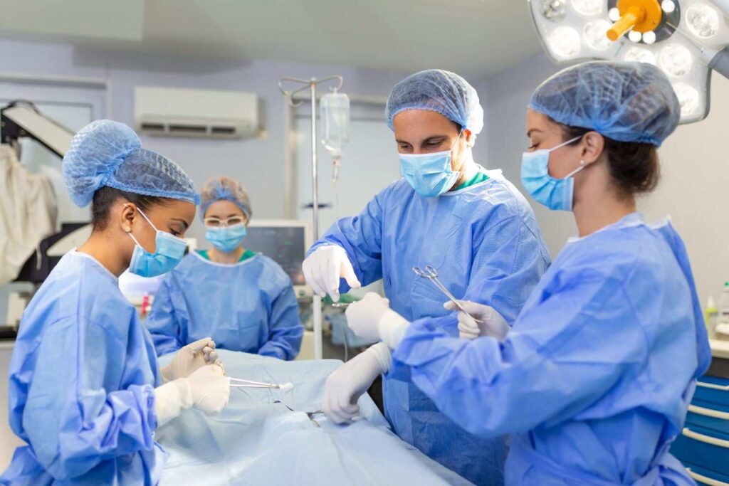 diverse team professional surgeon assistants nurses performing invasive surgery patient hospital operating room surgeons talk use instruments real modern hospital