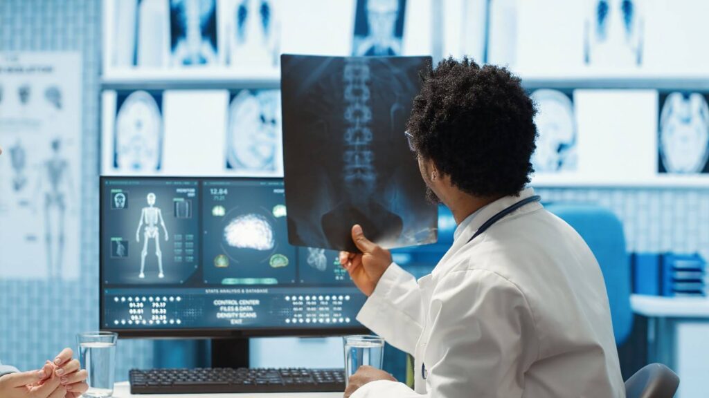 physician reviewing mri scan x ray results with patient medical office